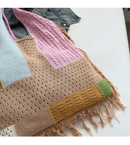 Close-up of colorful patchwork knit handbag with detailed fringe and texture