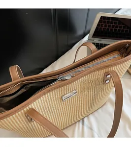Top view showing large straw tote bag capacity with zipper closure and brown leather handles