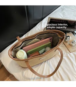 Top view of large woven tote bag interior showing ample storage for tablets and books