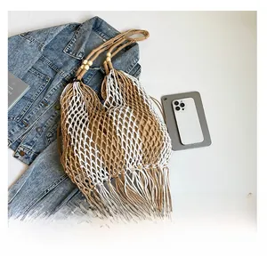 Detail of bohemian hand-woven tote bag featuring wooden beads and long fringe accents
