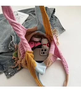 Top view of spacious interior of colorful patchwork knit tote bag with tassel details