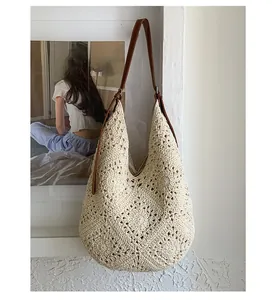 Detail of hollow woven texture on beige tote bag with premium brown leather strap