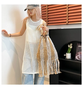 Detailed view of bohemian woven tote bag with dense fringe and hollow crochet texture