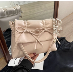 Détail du cabas matelassé rose abricot avec nœuds et poignée en foulard de soie imprimé