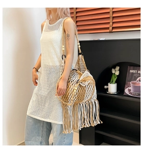 Detail of woven mesh texture with long tassels and wooden beaded straps on a tote bag