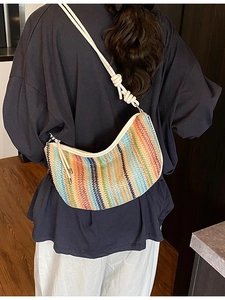 Colorful woven hobo shoulder bag with vertical stripes and knotted cream rope strap