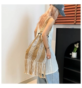 Detail of bohemian woven tote bag with long tassels and decorative wooden beads