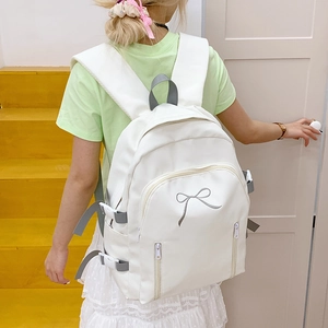Détails du sac à dos blanc avec broderie nœud gris et boucles latérales réglables