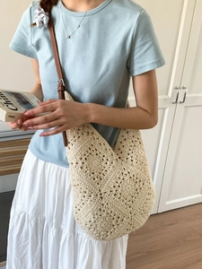 Beige sunflower crochet hobo bag with brown leather strap and intricate floral pattern