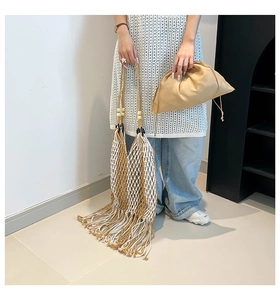 Detail of woven boho tote with wooden beads, fringe tassels and canvas drawstring liner