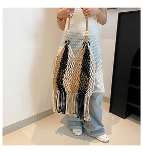 Close-up of bohemian woven tote bag featuring tricolor stripes and long tassel fringe