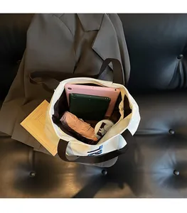 Top view of large canvas tote bag showing spacious interior with tablet and umbrella