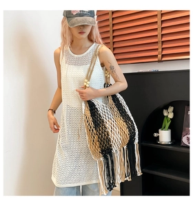 Detailed view of bohemian woven tote bag with fringe tassels and wooden bead handle
