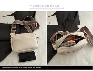 Detail view of cream lychee texture crossbody bag with wide strap and inner pocket