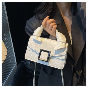 Detail of white snakeskin texture handbag with minimalist black square buckle and knotted handle