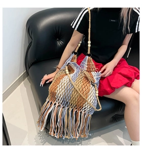 Handwoven ethnic shoulder bag with blue and brown patterns and long fringe tassels