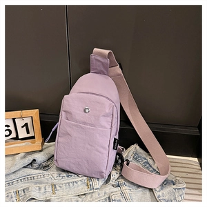 Detail of lavender nylon chest bag with adjustable strap and front zipper pocket