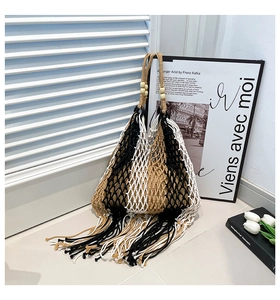 Close-up of tricolor woven tote bag with long tassels and wooden bead details