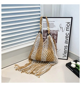 Close-up of woven mesh tote with long tassels, wooden beads and black ring details