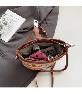 Rainbow woven bucket bag with leather handles showing spacious interior for essentials