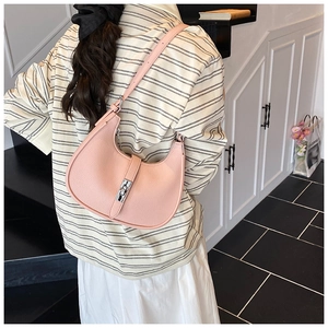 Pink lychee grain leather hobo bag with silver metallic clasp shown on a model