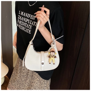 Detail of white litchi grain leather hobo bag with silver buckle and pearl doll charm