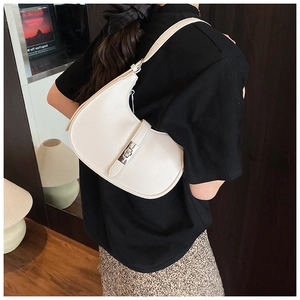 Detailed texture of white pebble leather hobo bag with a silver metal twist lock