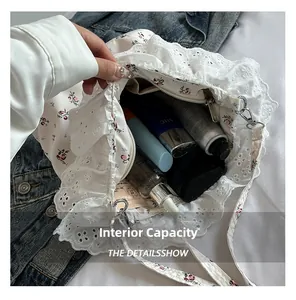 Detail view of the spacious inner compartment of the floral lace shoulder bag for essentials