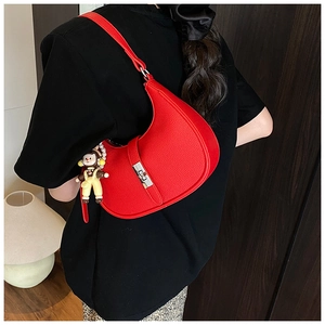 Red pebbled leather crescent underarm bag with silver buckle and cute bear charm detail