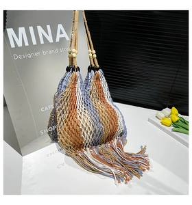 Detail of bohemian hand-woven tote bag featuring colorful tassels and wooden bead strap