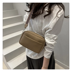 Brown litchi grain PU leather crossbody bag with wide striped strap and front pocket