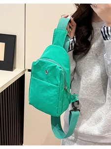 Vibrant lime green nylon crossbody chest bag with adjustable strap and multiple compartments