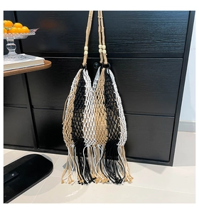 Detailed view of bohemian woven tote bag featuring fringe tassels and wood bead handles
