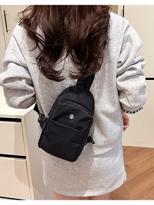Women's black casual chest bag in waterproof nylon with adjustable shoulder strap