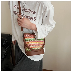 Rainbow woven bucket bag with brown leather details and colorful summer stripes