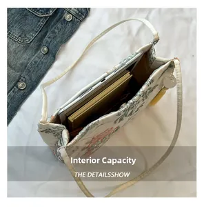 Interior view of embroidered tote bag showing large capacity for tablet and notebooks