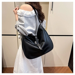 Detailed view of black large capacity tote bag featuring silver buckle and soft leather texture
