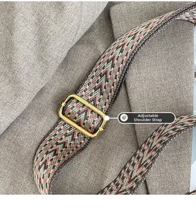 Close-up of adjustable woven shoulder strap with retro geometric patterns and gold metal buckle
