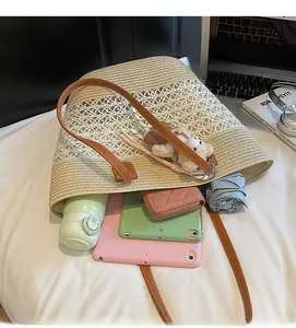 Interior view showing the large capacity of a woven straw tote with daily essentials