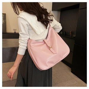 Macro view of a pink large-capacity hobo bag with glossy finish and metal buckle