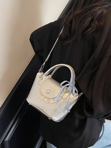 Silver wrinkled bucket bag with lace trim and blue checkered bow accessory
