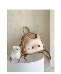 Detail of cute cat shaped backpack in brown leather with 3D ears and plush bear charm