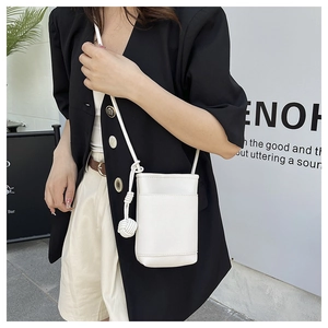 Close-up of white litchi pattern mini crossbody phone bag with knot decorative charm