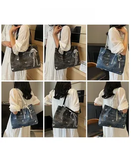 Detail of denim tote bag featuring butterfly embroidery and delicate lace bow accents