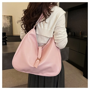 Rear view of a model wearing the pink leather tote bag in a modern interior setting