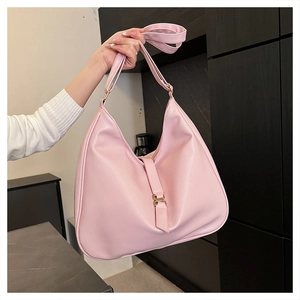 Detail of light pink hobo shoulder bag with large capacity and gold buckle closure