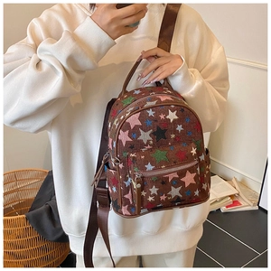 Brown canvas mini backpack featuring colorful star patterns and textured fabric detail