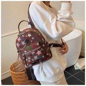 Detailed view of casual backpack featuring colorful star embroidery on canvas material