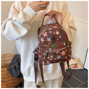 Brown mini canvas backpack featuring colorful star embroidery and adjustable straps