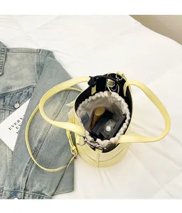 Detailed top view of a light yellow bucket bag with large capacity and drawstring closure